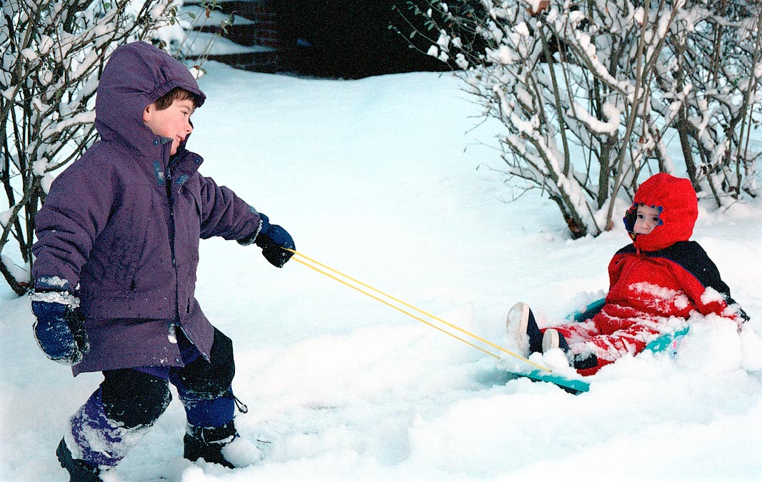 Eytan pulling Noah in his sled; ; Newton, MA; 1/20/2002