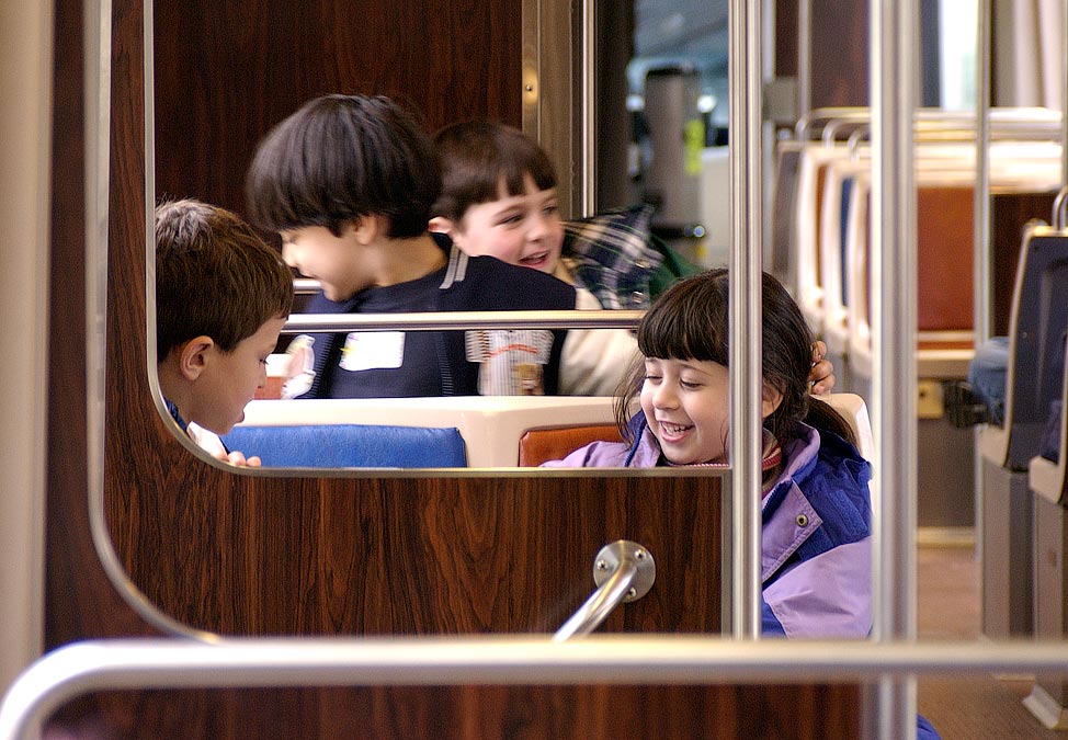 BITC trip to Boston Science Museum; Returning on the MBTA; ; L-R: Nathan, Devin, Anthony, Noam; ; Nikon D1X; 4/3/2002 12:00:06.5 PM; Color; Data Format: RAW (12-bit); Compression: None; Image Size: Large (3008 x 1960); Lens: 28-105mm f/3.5-4.5; Focal Length: 105mm; Exposure Mode: Aperture Priority; Metering Mode: Multi-Pattern; 1/60 sec - f/4.5; Exposure Comp.: +2/3 EV; Exposure Difference: 0 EV; Flash Sync Mode: Not Attached; Sensitivity: ISO 800; Color Mode: Mode II (Adobe RGB); Hue Adjustment: 3; White Balance: Direct sunlight; Tone Comp: Normal; Sharpening: Normal