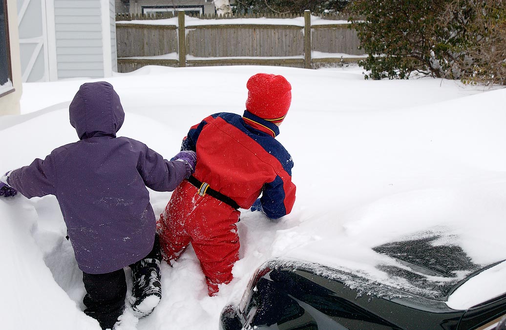 Blizzard, wind blown snow in side yard; Noah and Eytan; Newton, MA