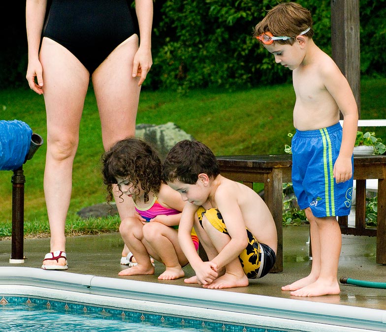 Eva, Shayna, Benji and Noah staring at a worm.  Eytan was the only one willing to fish it out, but it started to thunder.; West Dover; VT; US