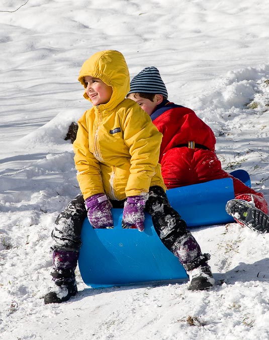 Noah and Eytan sledding on Grandma and Grandpa\'s front yard.; Williamstown; MA; USA