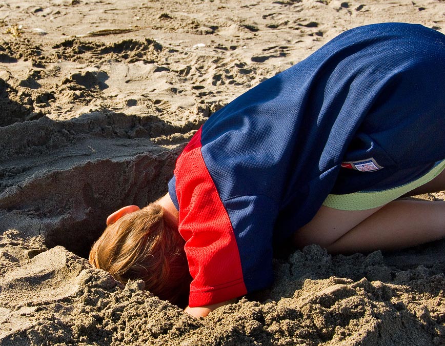 Noah digging in the sand; Seaside; OR; US