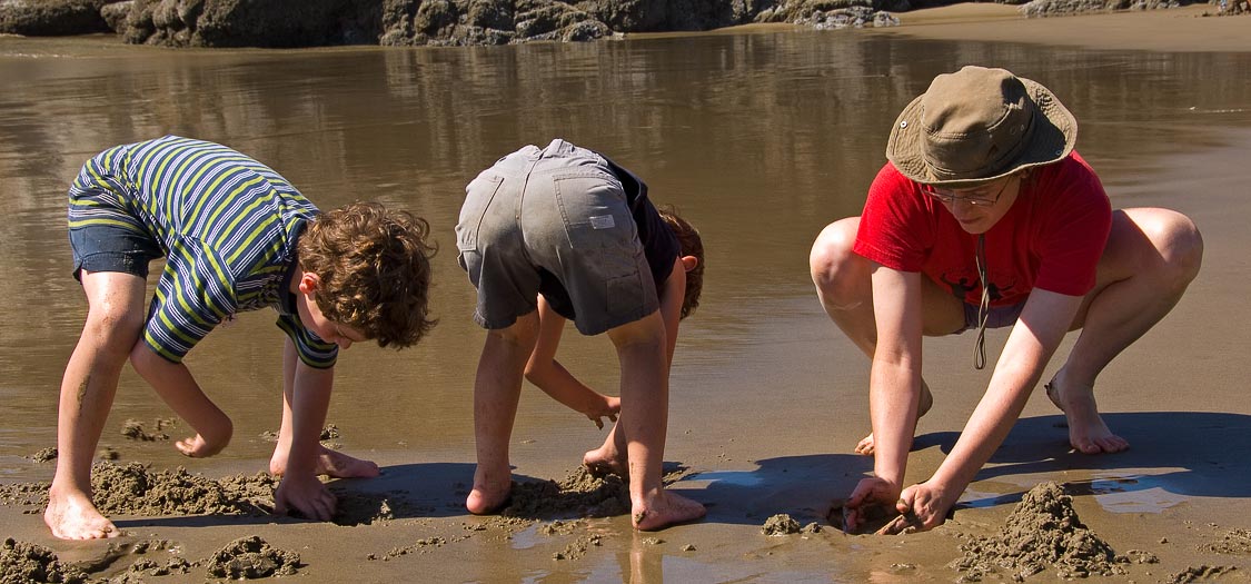 Eytan, Anne and Noah making drip sand castles; Beach south of Cannon Beach; OR; US