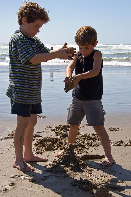 Eytan and Noah making drip sand castles; Beach south of Cannon Beach; OR; US
