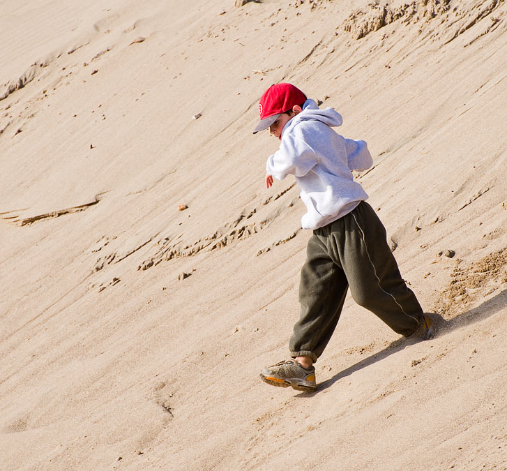 Noah running down a sand dune; Point Reyes; CA; US