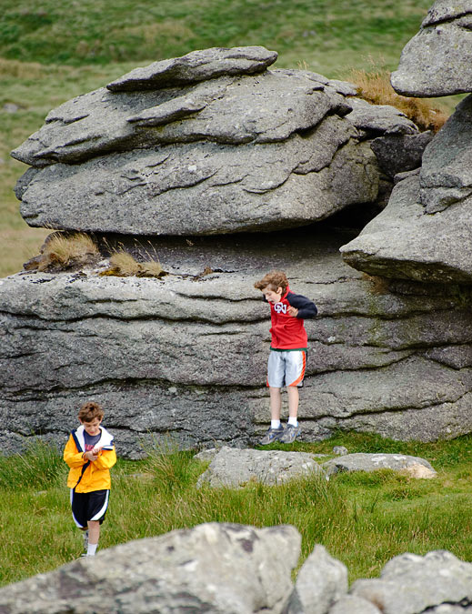 Noah and Eytan jumping from King\'s Tor; Dartmoor; Devon; England