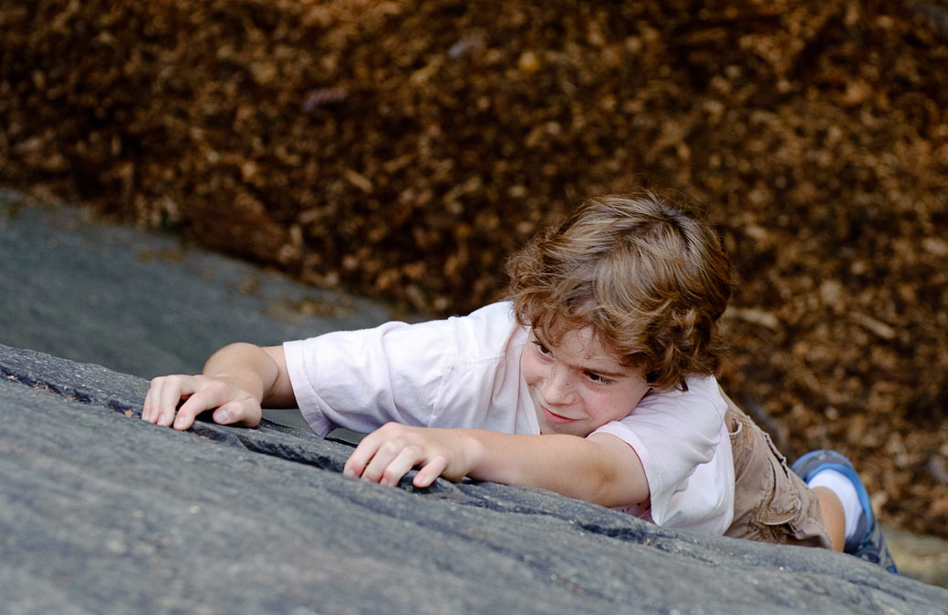 Eytan climbing rocks in Central Park; New York; NY; US