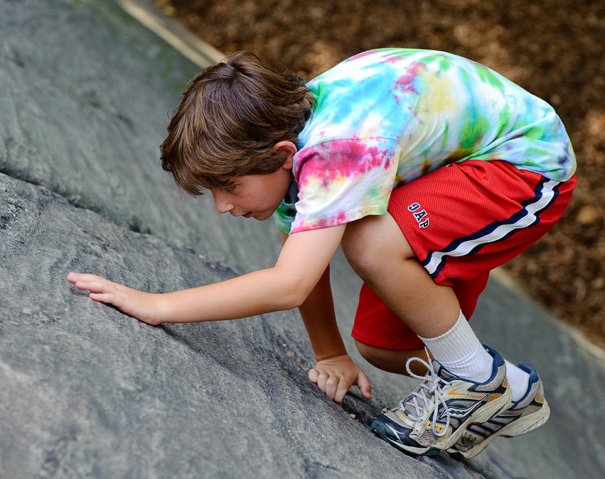Noah climbing rocks in Central Park; New York; NY; US