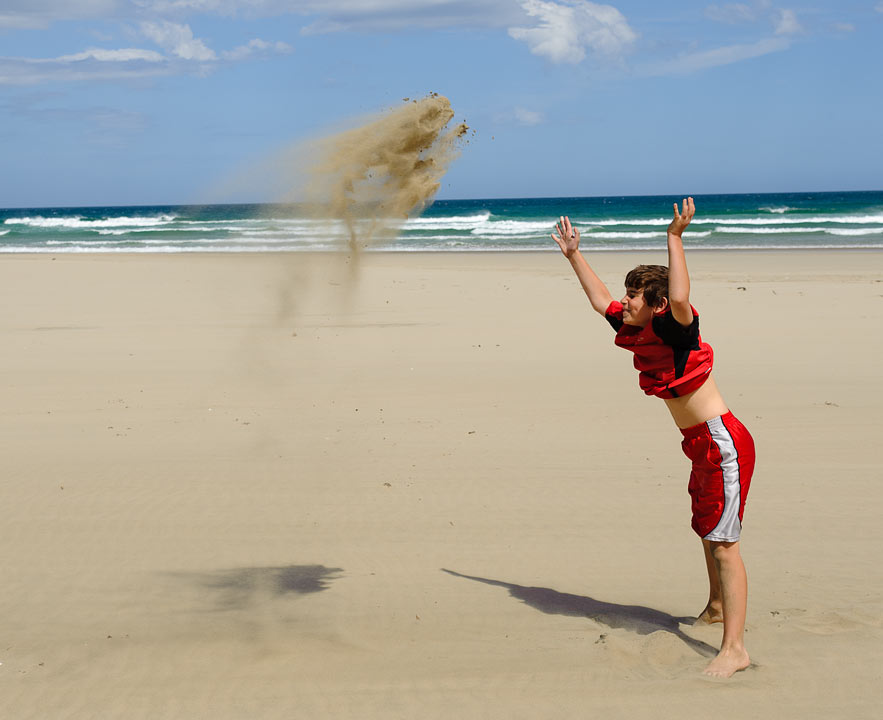 Noah throwing sand; Southland; South Island; New Zealand