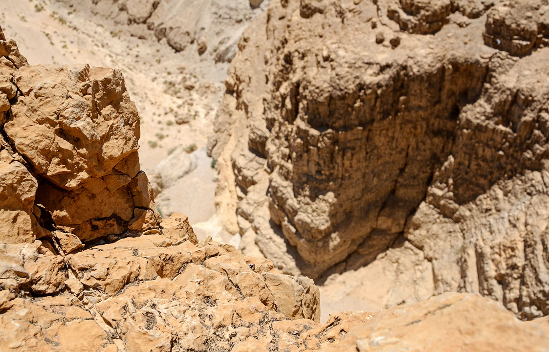 Eytan\'s perspective from Michael\'s picture of him crawling to the edge looking down; Qumran; MA; Israel