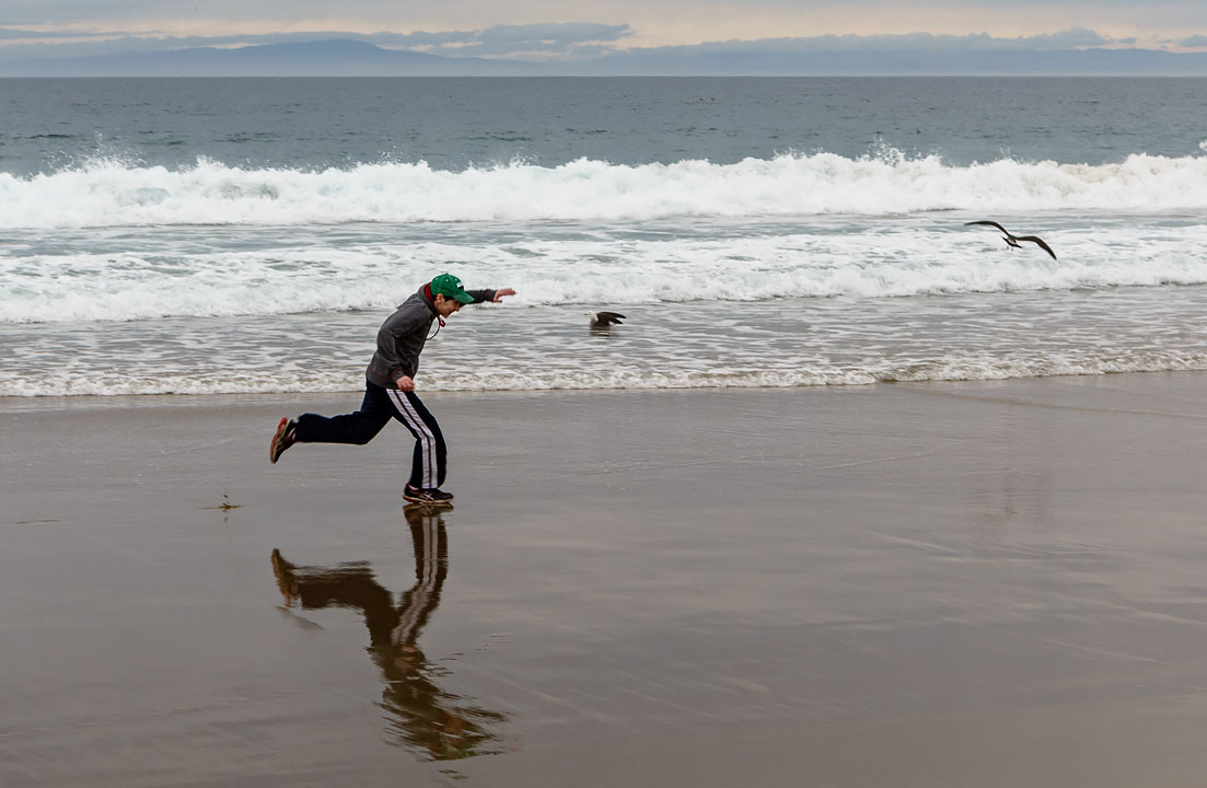 Eytan running on the beach; Monterey; CA; USA