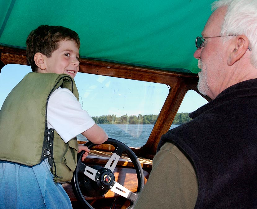 L-R: Captain Eytan and Peter drive Peter\'s motor boat on Lake Champlain